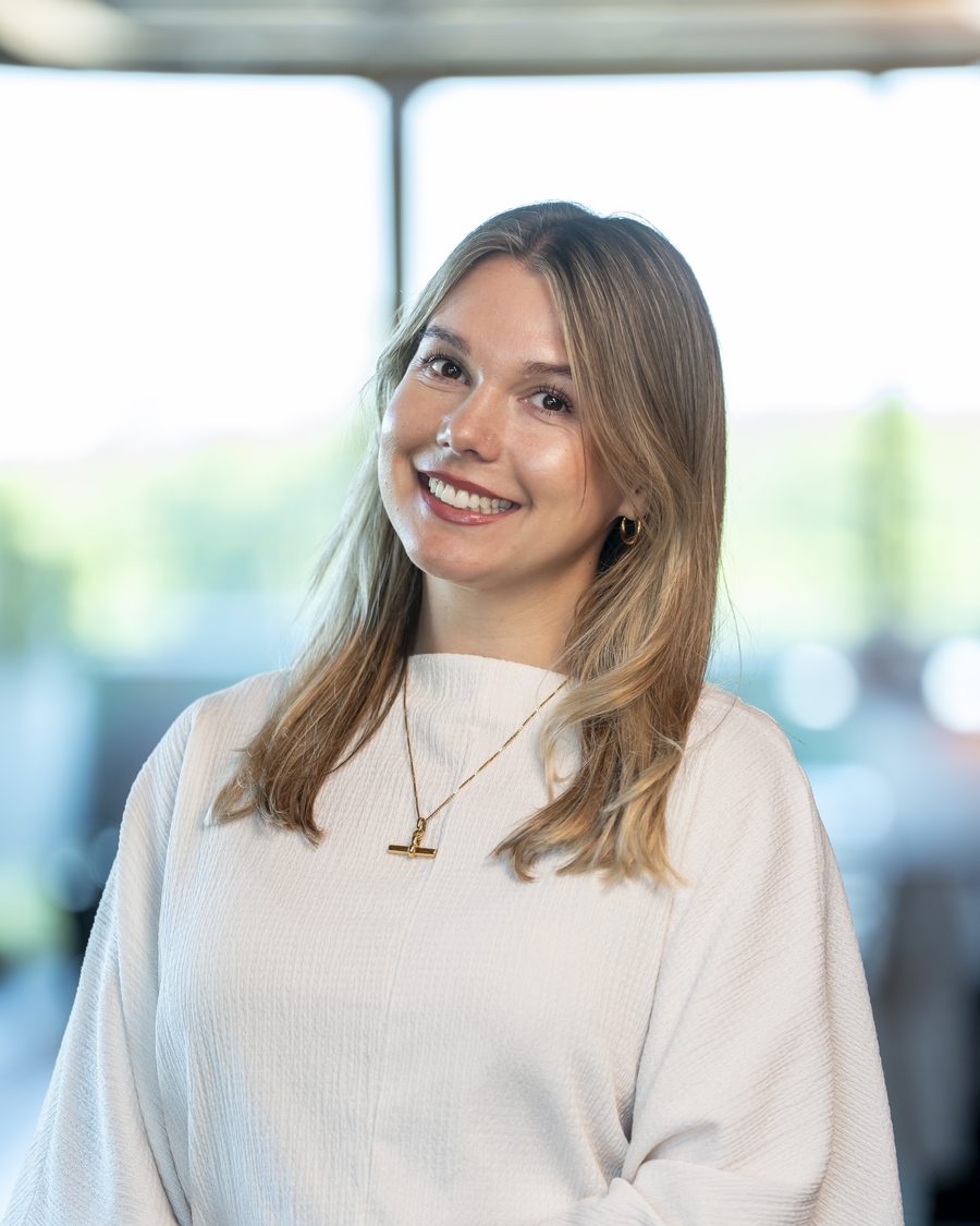 Holly Mann, transformational coach, smiling in a bright office